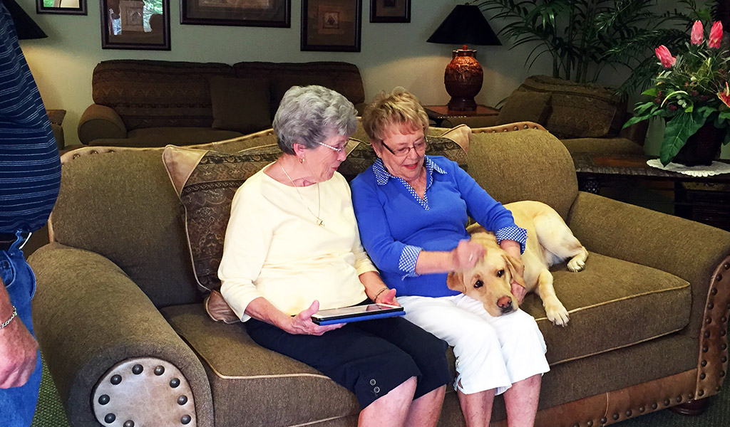 Senior Ladies Playing with Pet in Our Activity Room